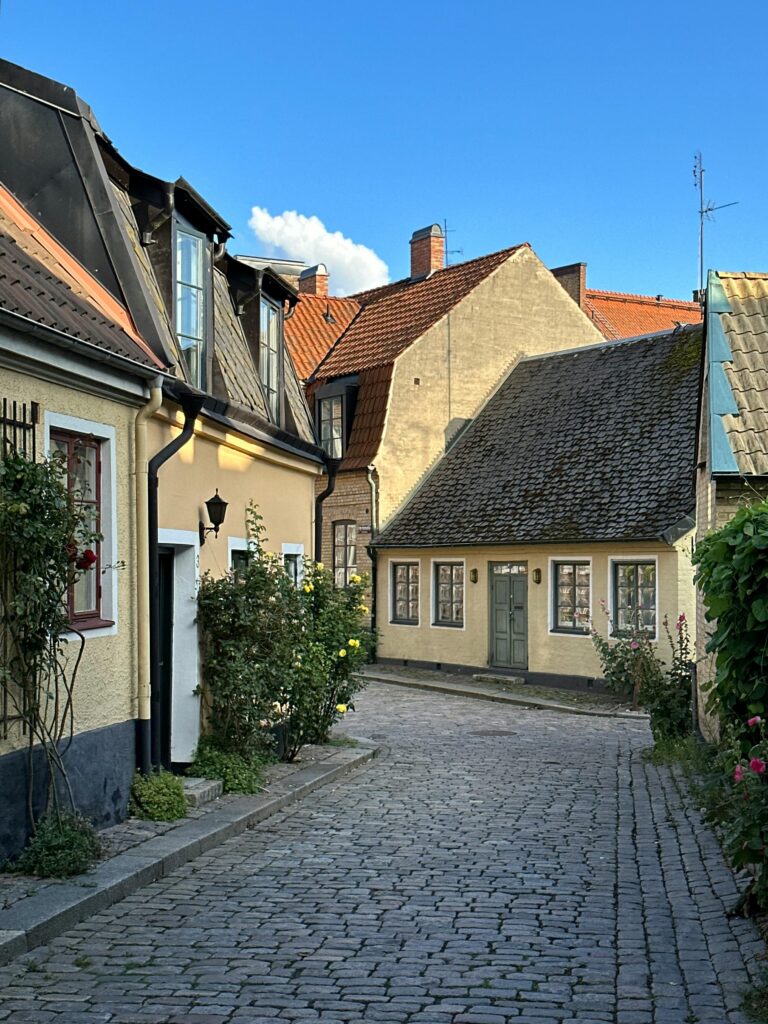 Quaint cobblestone street scene with historic homes in Lund, Sweden. Perfect for travel and architecture enthusiasts.